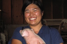 Ednee Yoshioka holding piglet